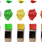 A selection of paintbrushes and paint in different colours.