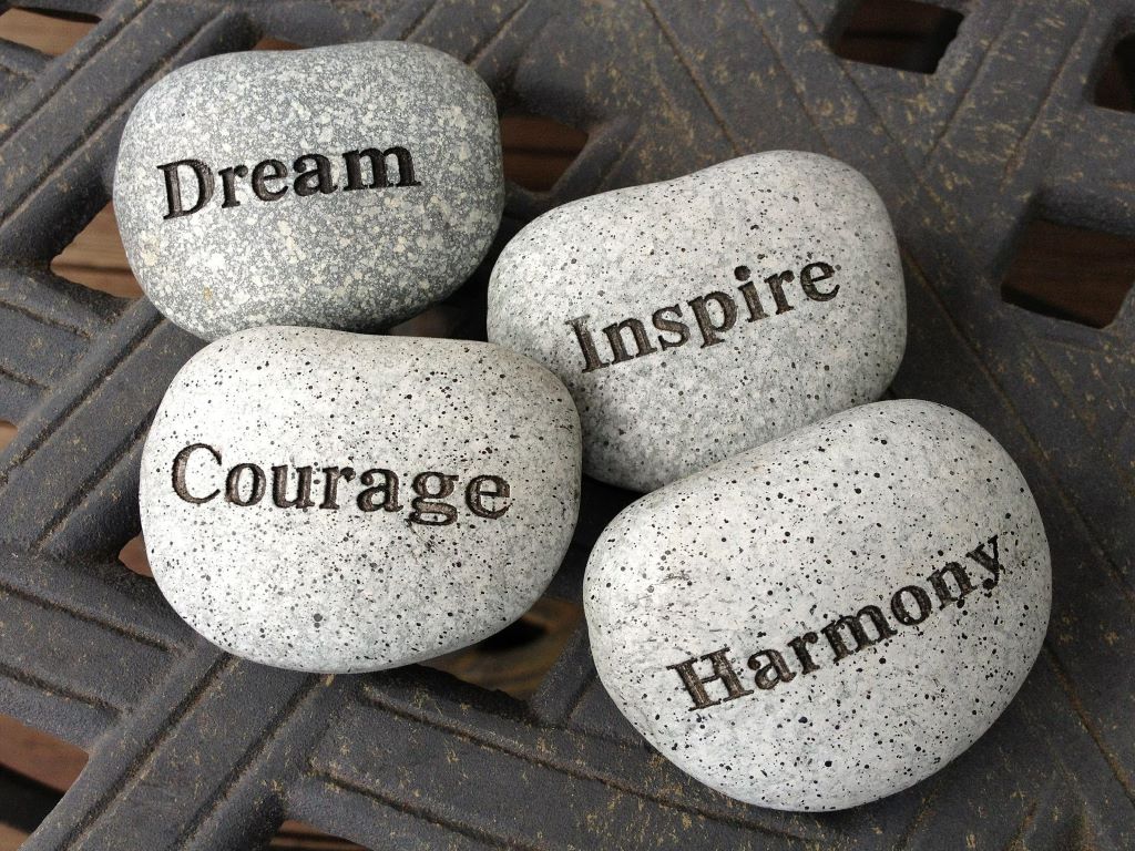 Four stones on which are written teh words Dream, Inspire, Courage and Harmony.