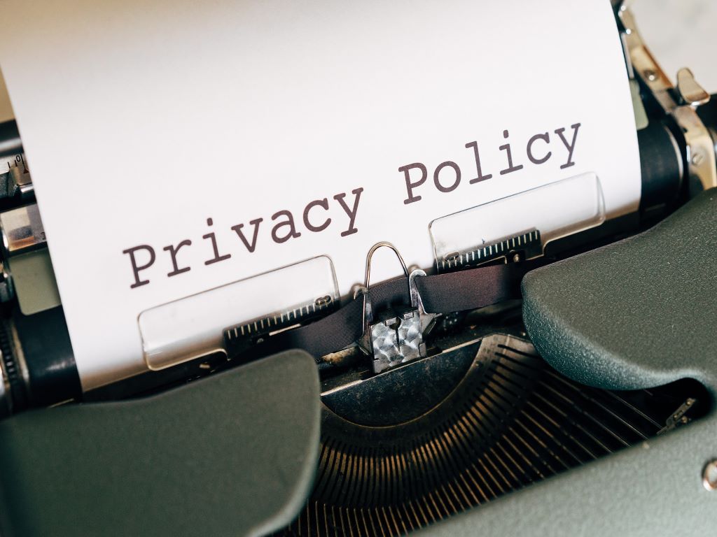 a typewriter with a piece of paper on which are the words Privacy Policy.