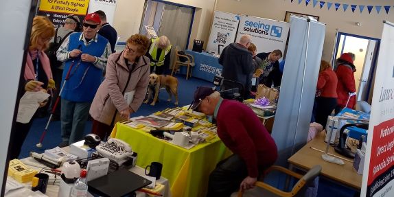 A number of information stands with people looking at products and talking to exhibitors